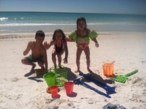 Three kids playing on the beach